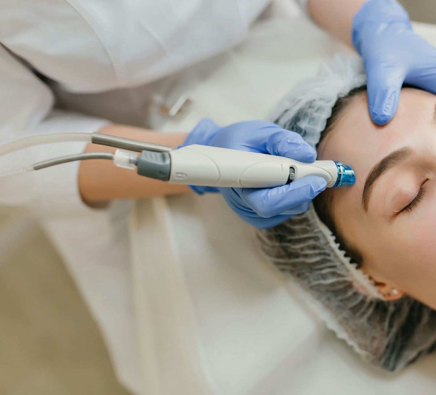 a woman getting a facial peel from a doctor