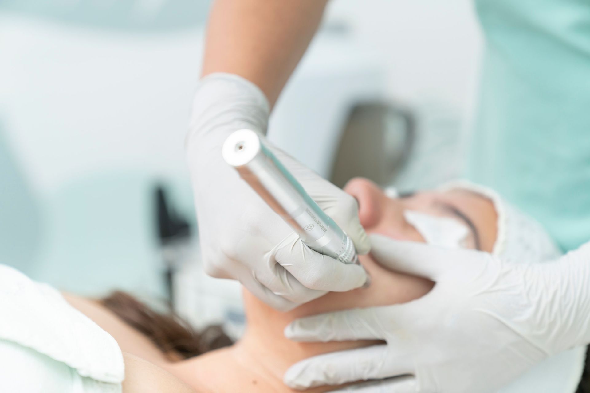 Close-up of a cosmetic treatment being performed in a clinical environment.