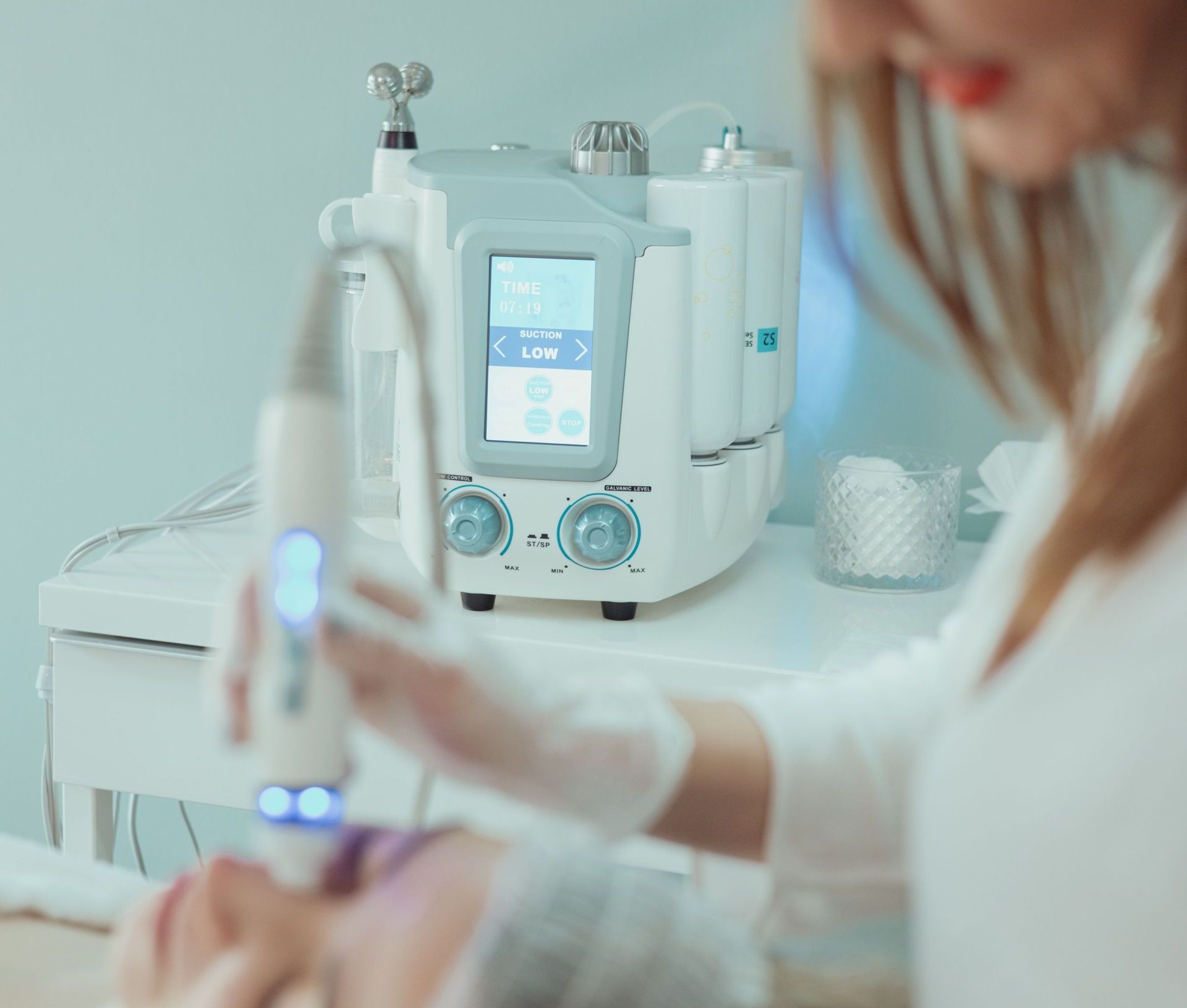 Close-up of a hydrafacial treatment being applied in a modern beauty clinic.